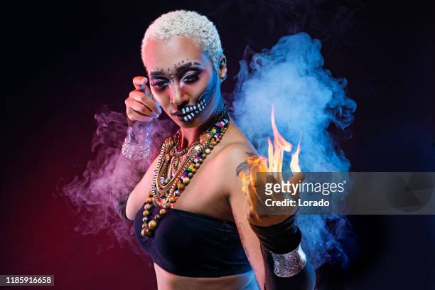santeria voodoo queen casting a fire spell - voodoo doll stock pictures, royalty-free photos & images