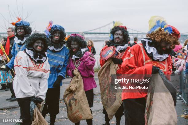 People dressed as Zwarte Piet or Black Pete pose during an event celebrating the arrival of Sinterklaas on 1st December 2019 in Uerdingen, Germany....