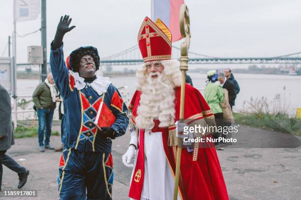 Sinterklaas and his helpers Zwarte Piet or Black Pete arrives at Uerdingen harbor on 1st December 2019 in Uerdingen, Germany. The Dutch tradition of...
