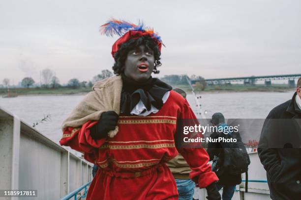 Sinterklaas and his helpers Zwarte Piet or Black Pete arrives at Uerdingen harbor on 1st December 2019 in Uerdingen, Germany. The Dutch tradition of...