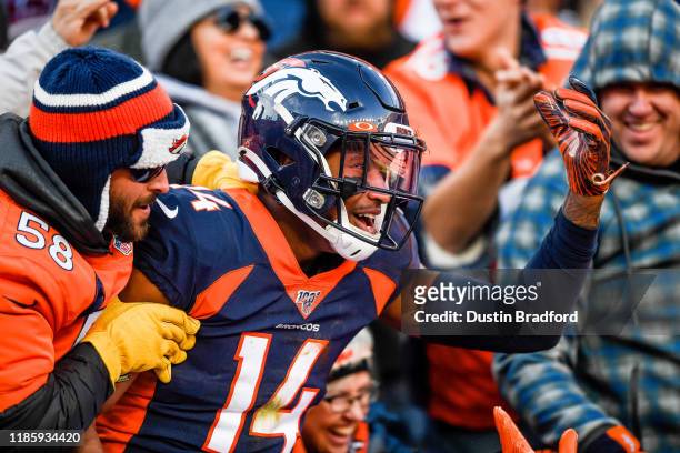 Courtland Sutton of the Denver Broncos is congratulated by fans after a first quarter touchdown catch against the Los Angeles Chargers at Empower...