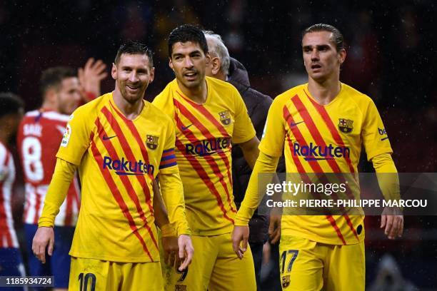 Barcelona's Argentine forward Lionel Messi, Barcelona's Uruguayan forward Luis Suarez and Barcelona's French forward Antoine Griezmann celebrate at...