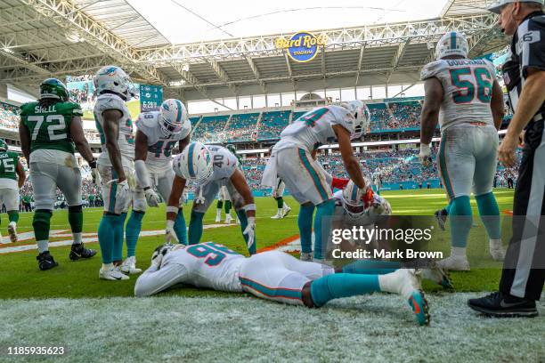 Taco Charlton of the Miami Dolphins reacts to just missing a touchdown against the New York Jets in the foruth quarter at Hard Rock Stadium on...