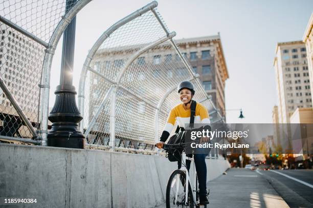 young woman with bike and messenger bag in the city - tacoma stock pictures, royalty-free photos & images