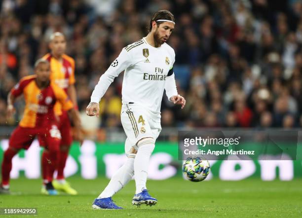Sergio Ramos of Real Madrid scores his sides third from the penalty spot during the UEFA Champions League group A match between Real Madrid and...