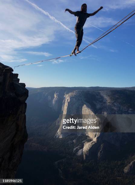 taft point yosemite highliner walking in space - highlining stock pictures, royalty-free photos & images
