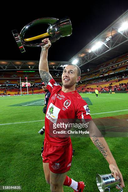 Quade Cooper of the Reds hold the trophy after winning the 2011 Super Rugby Grand Final match between the Reds and the Crusaders at Suncorp Stadium...