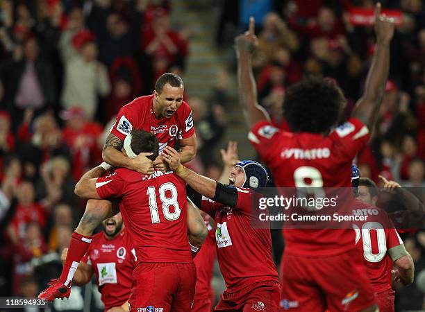 Quade Cooper of the Reds celebrates with winning the 2011 Super Rugby Grand Final match with team mates between the Reds and the Crusaders at Suncorp...