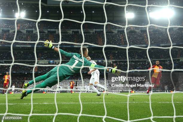 Karim Benzema of Real Madrid scores his team's fourth goal during the UEFA Champions League group A match between Real Madrid and Galatasaray at...