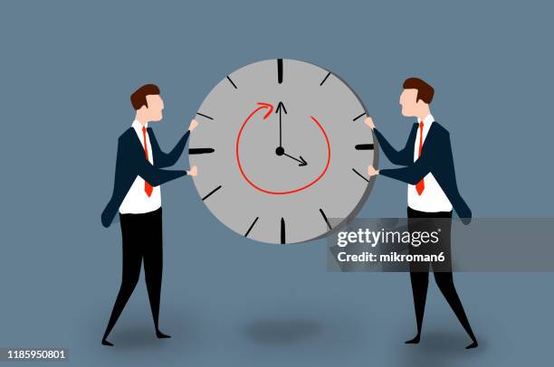 two men in a suit holding a clock - clocks go forward - fotografias e filmes do acervo