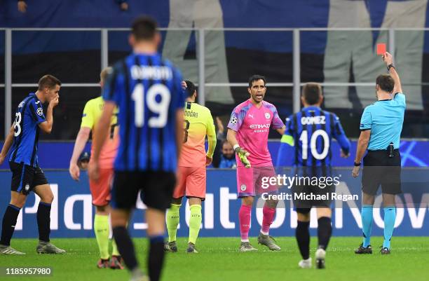 Claudio Bravo of Manchester City receives a red card from referee Aleksei Kulbakov during the UEFA Champions League group C match between Atalanta...