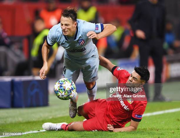 Nadiem Amiri of Bayer 04 Leverkusen fouls Santiago Arias of Atletico Madrid resulting in a red card during the UEFA Champions League group D match...