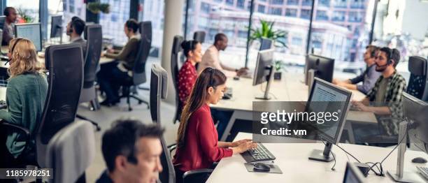 people in a call centre conducting market research - call centre digital stock pictures, royalty-free photos & images