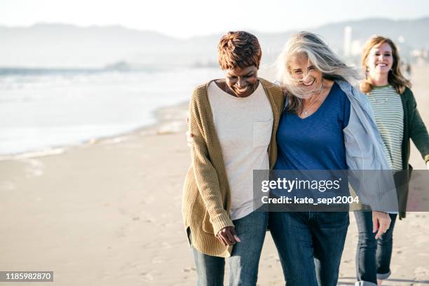 active seniors group on the beach - gay seniors stock pictures, royalty-free photos & images