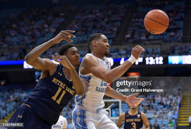 Juwan Durham of the Notre Dame Fighting Irish battles Garrison Brooks of the North Carolina Tar Heels for a rebound during the first half at the Dean...