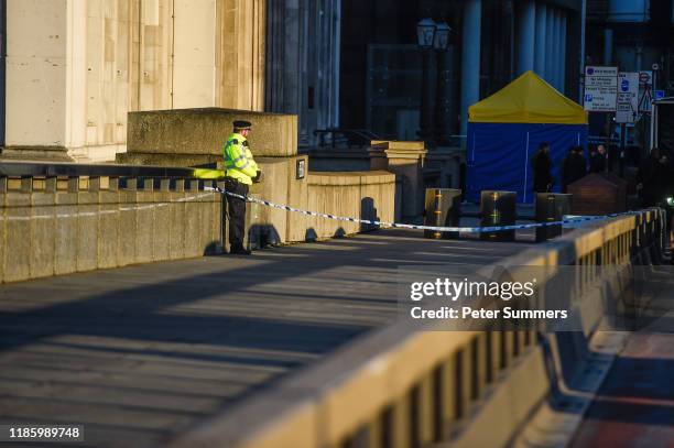 Police officer stands next to where Usman Khan was shot, on London Bridge, on December 2, 2019 in London, England. Usman Khan, a 28 year old former...