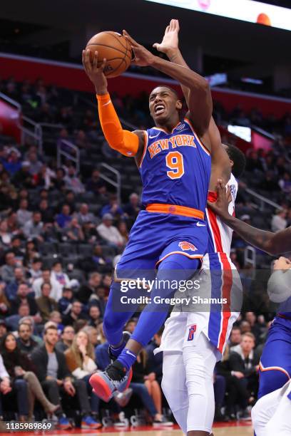 Barrett of the New York Knicks drives to the basket against Andre Drummond of the Detroit Pistons during the first half at Little Caesars Arena on...