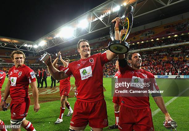 Reds captain James Horwill and team mate Ben Daley celebrate with the trophy after winning the 2011 Super Rugby Grand Final match between the Reds...