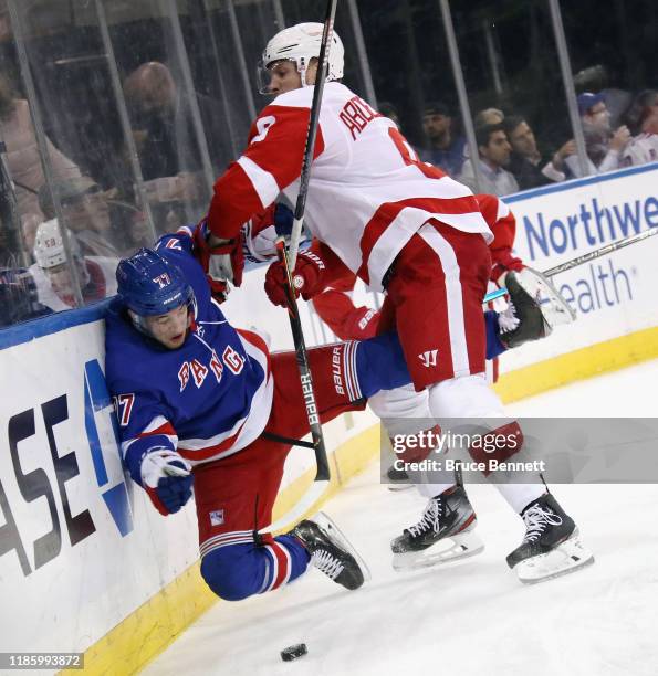 Tony DeAngelo of the New York Rangers is checked by Justin Abdelkader of the Detroit Red Wings during the first period at Madison Square Garden on...