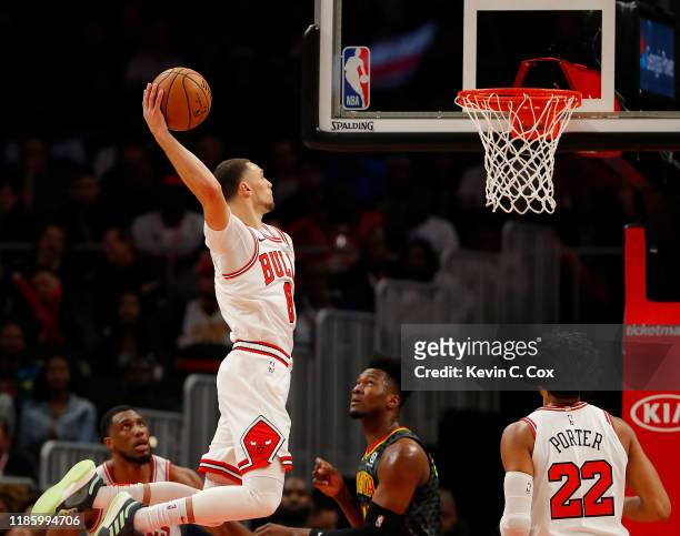 Zach LaVine of the Chicago Bulls dunks against Bruno Fernando of the Atlanta Hawks in the first half at State Farm Arena on November 06, 2019 in...