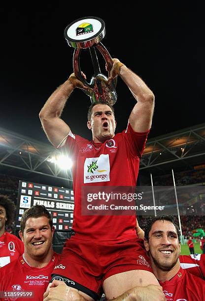 Reds captain James Horwill holds the trophy aloft as he is chaired by team mates during the 2011 Super Rugby Grand Final match between the Reds and...