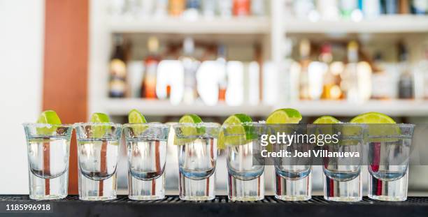 shots of tequila with salt and lime served in punta cana, dominican republic. - tequila foto e immagini stock