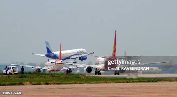 Aircraft from Indigo , Air India and Spicejet jostle for space on a runway at Indira Gandhi International Airport in New Delhi on July 13, 2011....