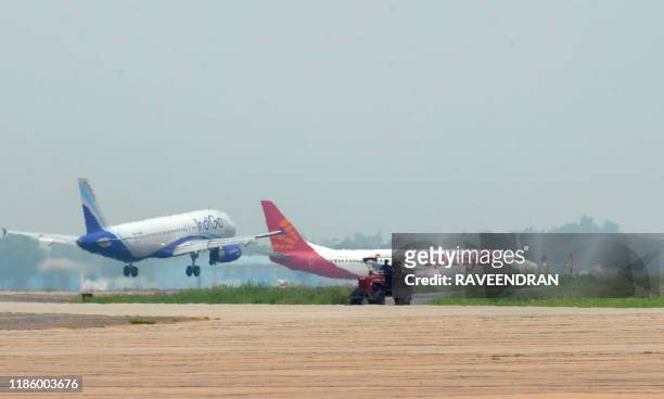 Aircraft from Indigo and Spicejet jostle for space on a runway at Indira Gandhi International Airport in New Delhi on July 13, 2011. Boeing have...