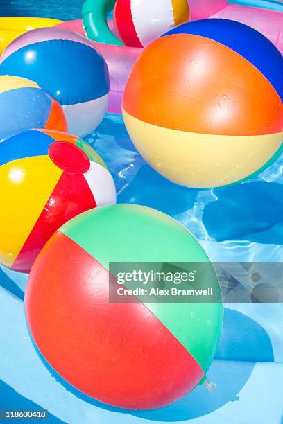 beach balls in pool - beach ball pool stock pictures, royalty-free photos & images