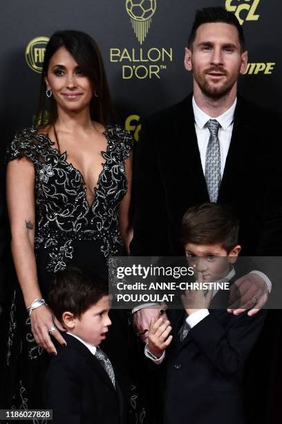 Barcelona's Argentinian forward Lionel Messi and his wife Antonella Roccuzzo and their sons Thiago and Mateo arrive to attend the Ballon d'Or France...