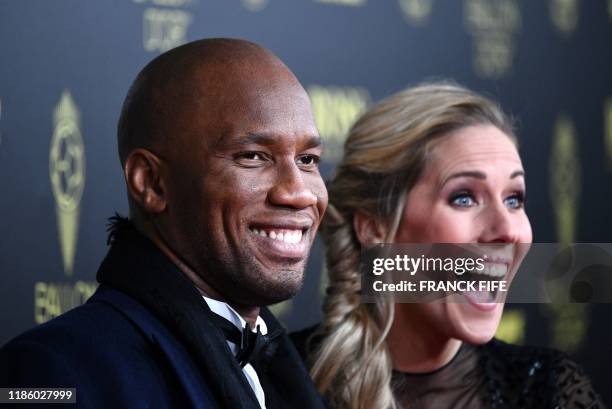 Former Ivorian forward Didier Drogba and French English tv host Sandy Heribert arrive to attend the Ballon d'Or France Football 2019 ceremony at the...