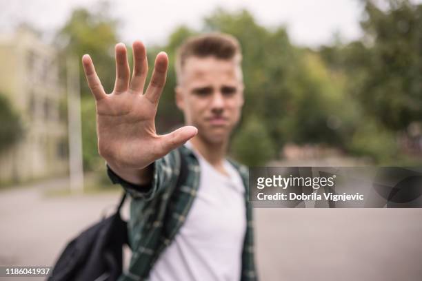 frustrated teenager putting his hand - rebellion stock pictures, royalty-free photos & images