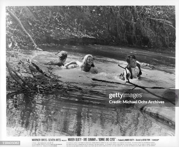 Faye Dunaway and Warren Beatty cross a river in a scene from the film 'Bonnie and Clyde', 1967.