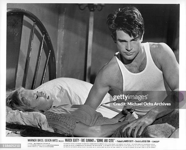 Faye Dunaway laying in bed next to Warren Beatty in a scene from the film 'Bonnie and Clyde', 1967.