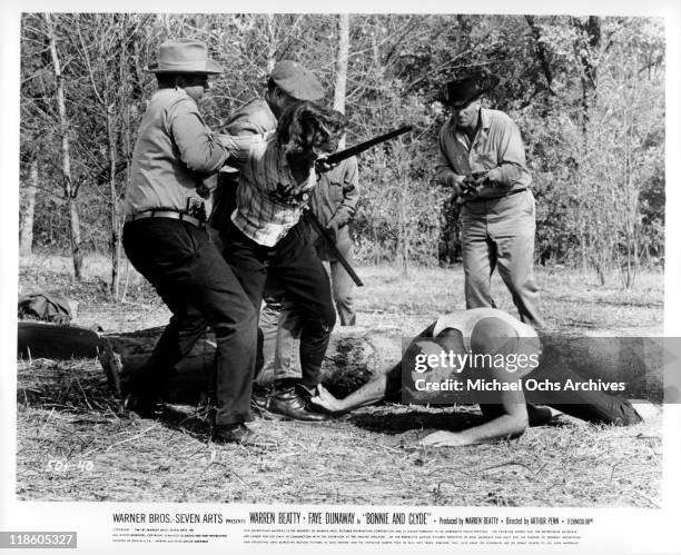 Men try to hold Faye Dunaway from seeing injured Warren Beatty in a scene from the film 'Bonnie and Clyde', 1967.