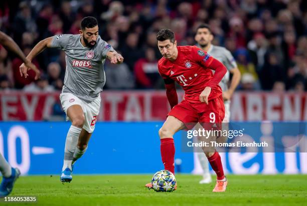 Robert Lewandowski of Munich is challenged by Yassine Meriah of Olympiacos during the UEFA Champions League group B match between Bayern Muenchen and...