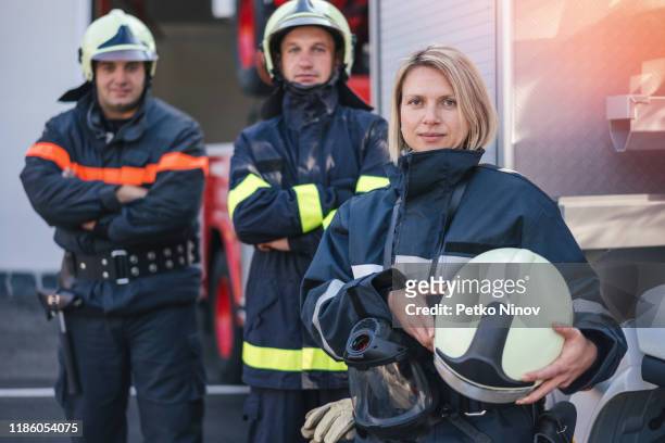 firefighters on duty - stereotypical stock pictures, royalty-free photos & images