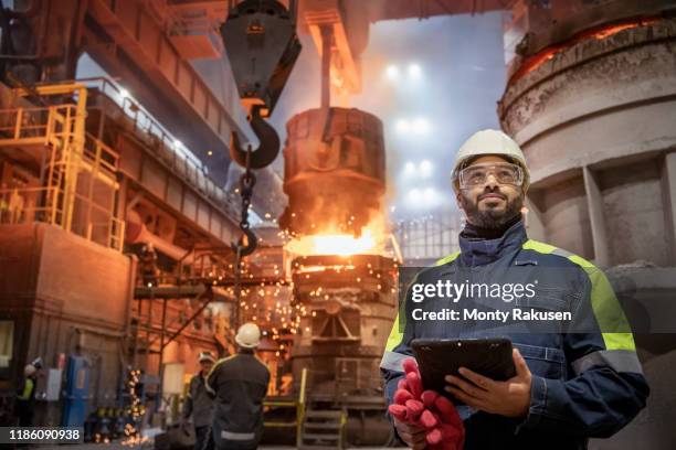 portrait of steelworker during steel pour in steelworks - steel factory stock pictures, royalty-free photos & images