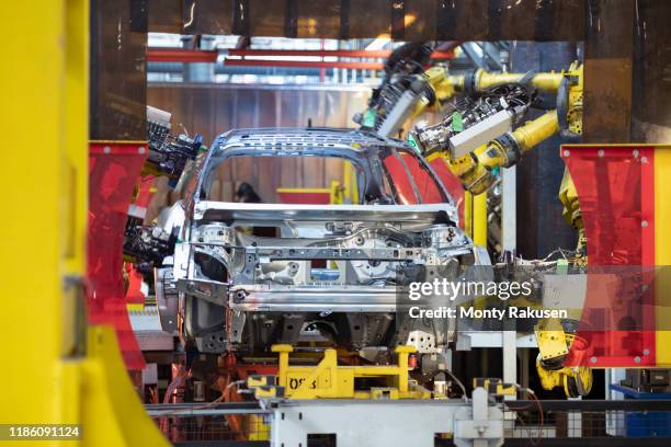 robot laser welders with car body in car factory - chassis stock pictures, royalty-free photos & images