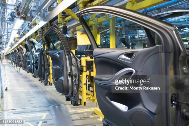 car doors on production line in car factory - car door stock pictures, royalty-free photos & images