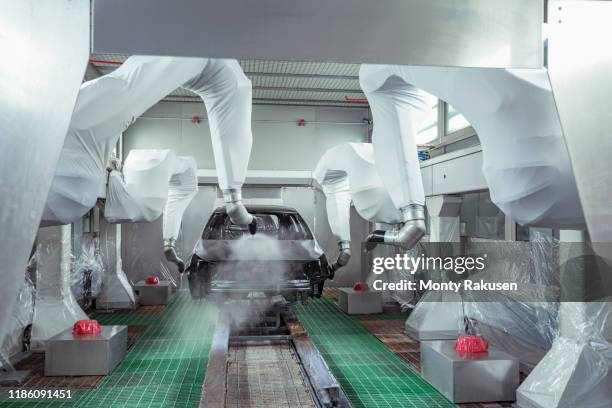 robot paint spraying car bodies in car factory - robot and car factory stock pictures, royalty-free photos & images