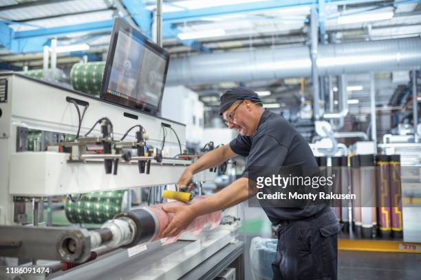 working rolling on print surface in print factory - printing stock-fotos und bilder