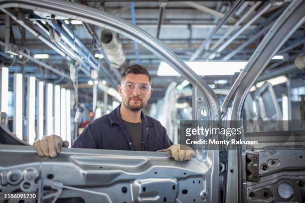 portrait of car body inspector in car factory - auto industry stock pictures, royalty-free photos & images