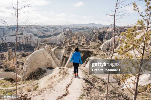 woman hiking in rocky valley, göreme, cappadocia, nevsehir, turkey - bachelorette stock pictures, royalty-free photos & images