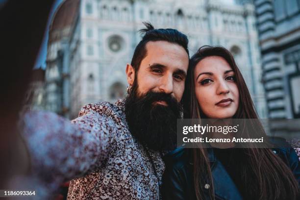 couple taking selfie in cafe, santa maria del fiore, firenze, toscana, italy - mimosa fiore fotografías e imágenes de stock