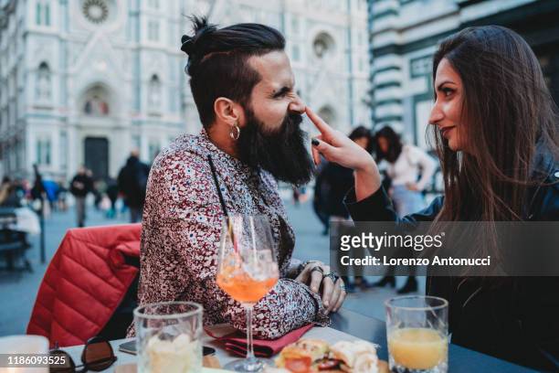 woman playfully tapping nose of man in cafe, santa maria del fiore, firenze, toscana, italy - elemento del design - fotografias e filmes do acervo