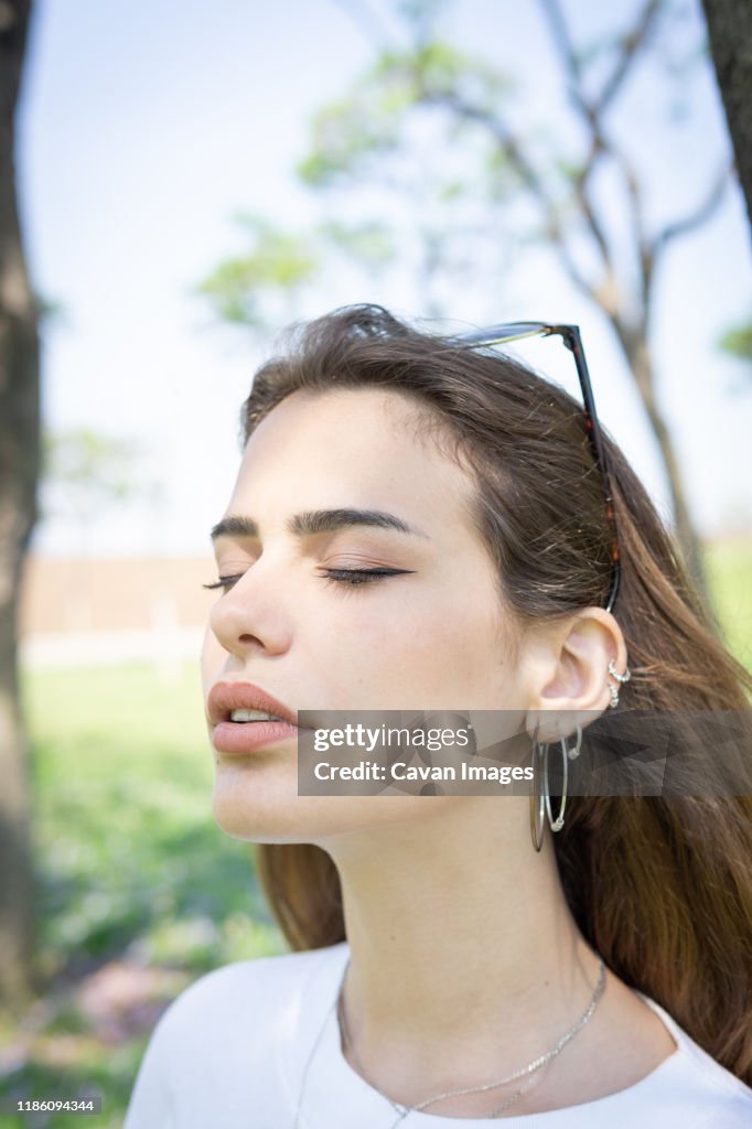 Beautiful smiling girl wearing casual summer clothes enjoys sunny day. Beauty, fashion shot.