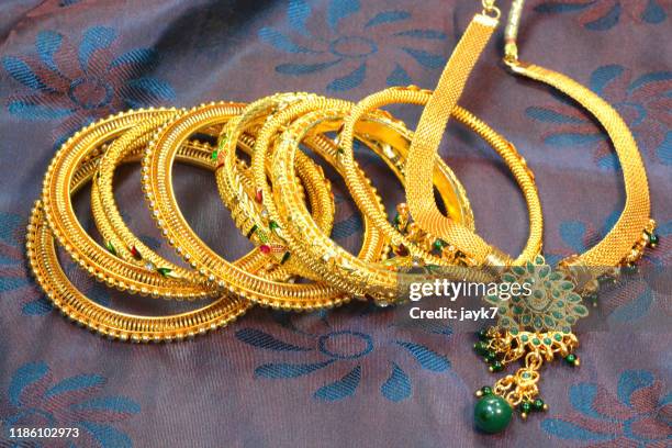 gold jewellery - bangle stock pictures, royalty-free photos & images