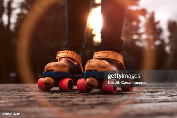 roller skating child playing outdoors with vintage toy roller skates - girl roller skates stock pictures, royalty-free photos & images