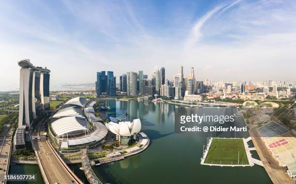 aerial panorama of the famous singapore downtown district skyline around the marina bay in southeast asia. - marina bay - singapore stock pictures, royalty-free photos & images
